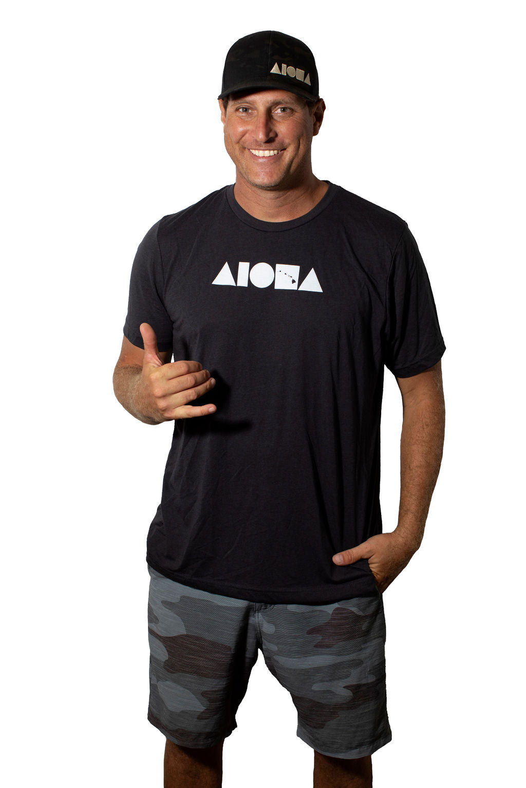Soley Aloha small business owner, Stu, wearing an Aloha Island Shapes Unisex Tee throwing a shaka in Maui Hawaii
