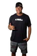 Man wearing Linton camo board shorts throwing shaka