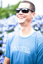 Man laughing wearing our Mauka to Makai Aloha Shapes sueded jersey tee in heather deep teal