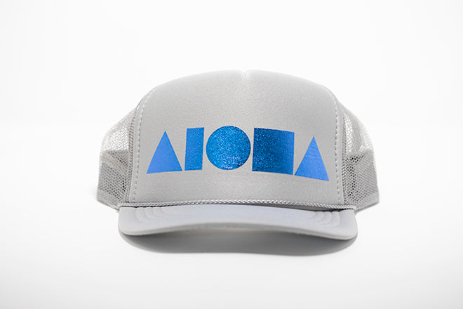 Youth foam trucker hat. Light grey foil printed with metallic blue Aloha Shapes ® logo