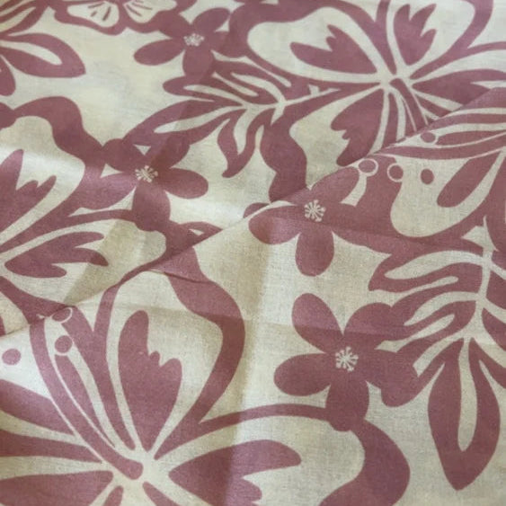Fabric with a red floral pattern on a beige background