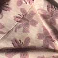 Floral patterned fabric with pink flowers on a light background