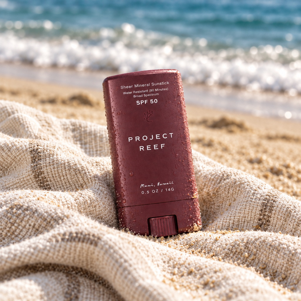 PROJECT REEF sunstick on a beach towel