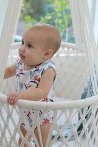 Baby in a bassinet wearing tropical onesie designed in Maui, Hawaii