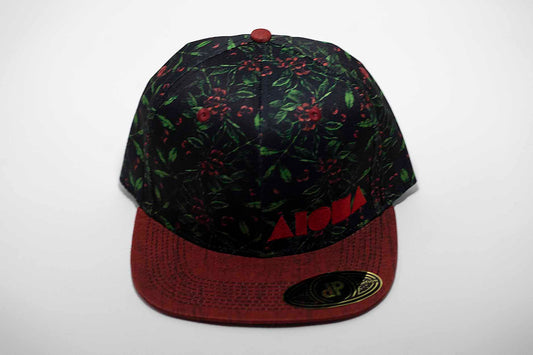 Adult flat brim snapback hat with coffee bean plant printed on black fabric. Red denim brim. Embroidered with red Aloha Shapes ® logo