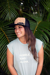 Young woman wearing a cork Aloha Shapes ® flat brim snapback hat