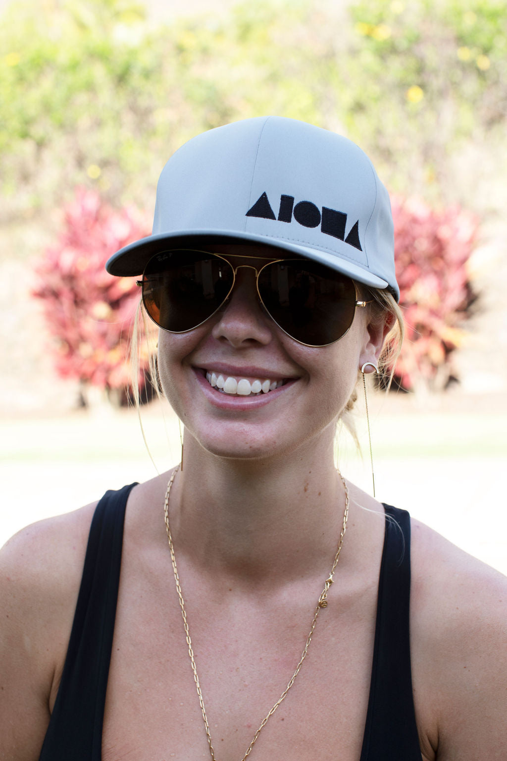 Young woman wearing a grey Aloha Shapes ® adult Flexfit hat