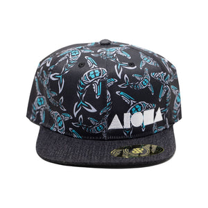Adult flatbrim snapback hat printed with blue and grey totem style whale prints embroidered with white Aloha Shapes® logo