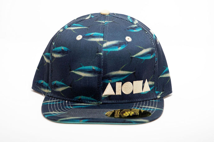 Blue and white ahi fish print on adult flat brim snapback. Embroidered with tan Aloha Shapes® logo