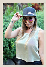 Woman wearing our Aloha Shapes® "Coral Reefer" snapback hat and a pair of pink aviator sunglasses.
