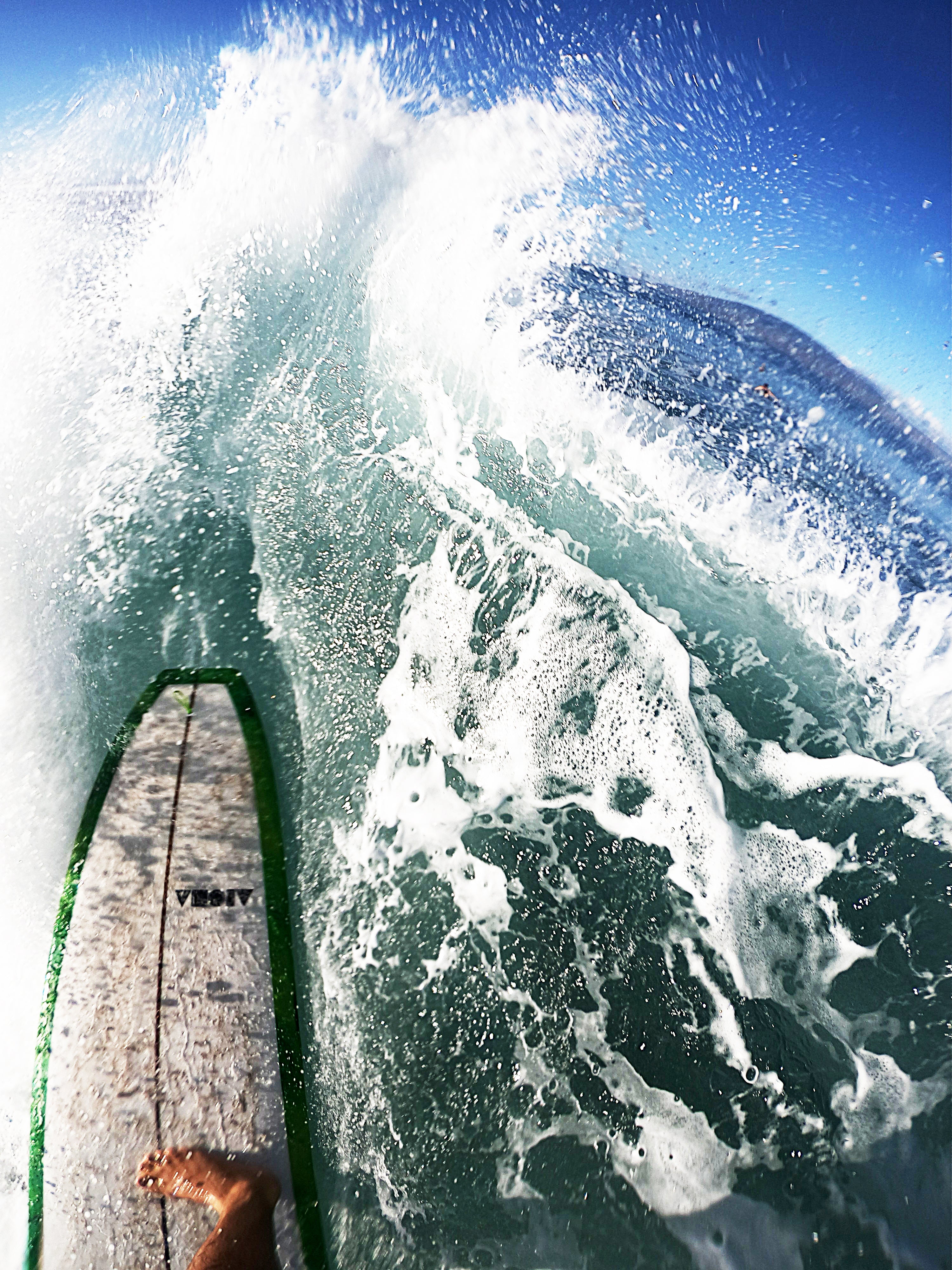 GoPro shot of our black decal sticker on surfboard of someone shredding the gnar
