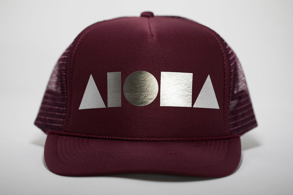 Adult foam trucker hat. Maroon brim and foam front panel foil printed with silver ALOHA Shapes ® logo. Maroon mesh back panels.