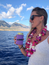 Woman on a boat holding beverage in a purple Aloha Shapes® koozie
