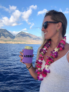 Woman on a boat holding beverage in a purple Aloha Shapes® koozie