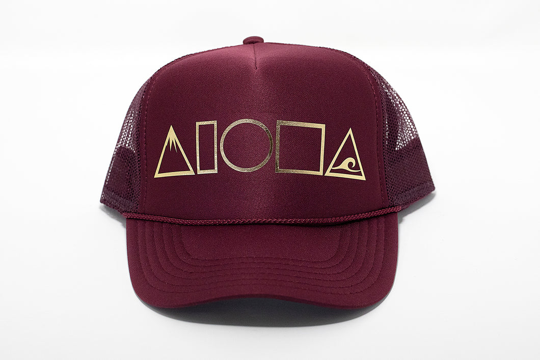 Maroon adult foam trucker hat printed with metallic gold Mauka to Makai Aloha Shapes logo