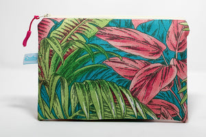 clutch size wet/dry bag in a pink/green tropical plant pattern. handmade in Maui, Hawaii