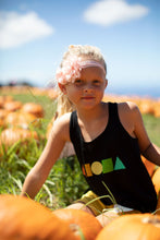 Young girl in pumpkin patch in upcountry Maui Hawaii wearing black Rainbow Aloha Shapes® youth racerback tank