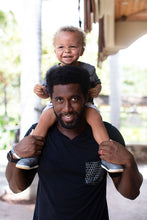 Father with son on his shoulders. Father is wearing Repeat Shapes pocket tee in black