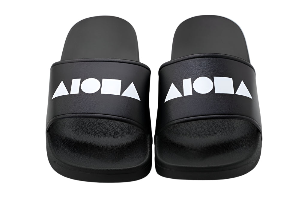 PVC Slide-in slippers printed with large white Aloha Shapes® logo on top strap