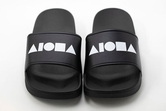 PVC Slide-in slippers printed with large white Aloha Shapes® logo on top strap