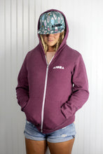 Blond dreadlocked girl wearing Aloha Shapes ® logo "Here Fishy Fishy" snapback hat and zip-up hoodie