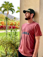 Man staring into the tropical mountainside of Maui Hawaii wearing Stacked Aloha Shapes® unisex sueded jersey tshirt