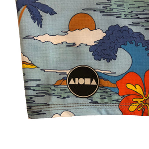 Close up detail of Aloha Surf Shapes logo on bottom left leg of Domes youth boardshorts