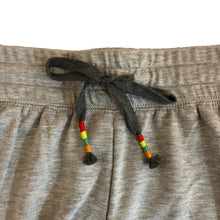 closeup detail of drawstring with rainbow colored tassel detail