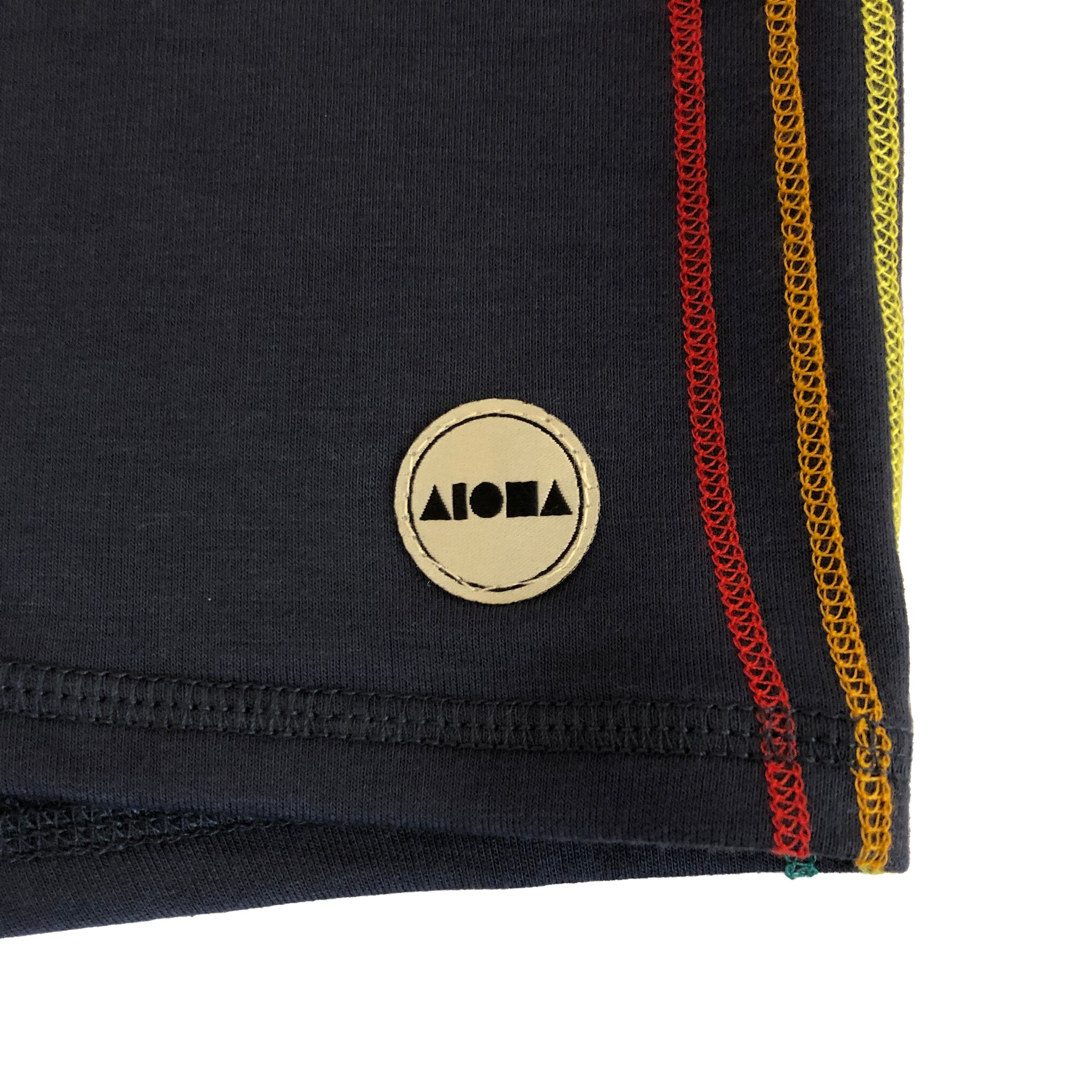 closeup detail of rainbow stripe accent and Aloha Shapes® logo label