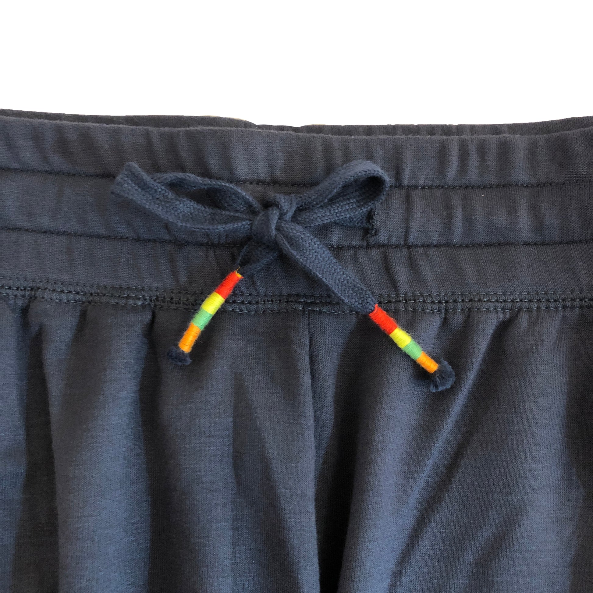 closeup detail of drawstring with rainbow stripe accent