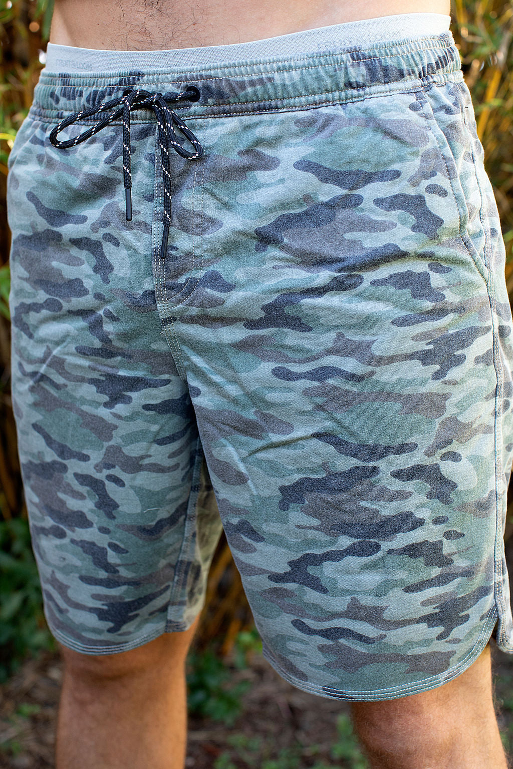 Man wearing Aloha Surf Shapes camo print "Loungin" sweat shorts in Maui Hawaii. Front view