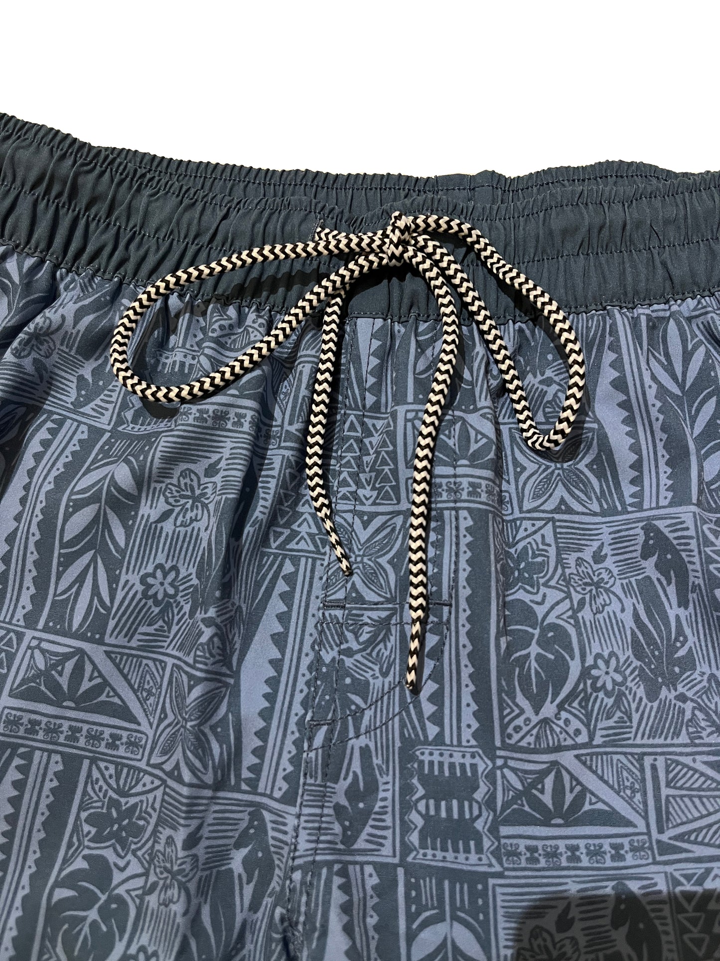 Closeup detail of elastic waistband with lasso style drawstring 