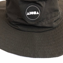 Closeup of Aloha Surf Shapes logo on black "Watson" boonie hat