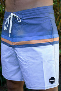 Front view of man wearing "Zonal" natural color Aloha Surf Shapes unisex surf shorts