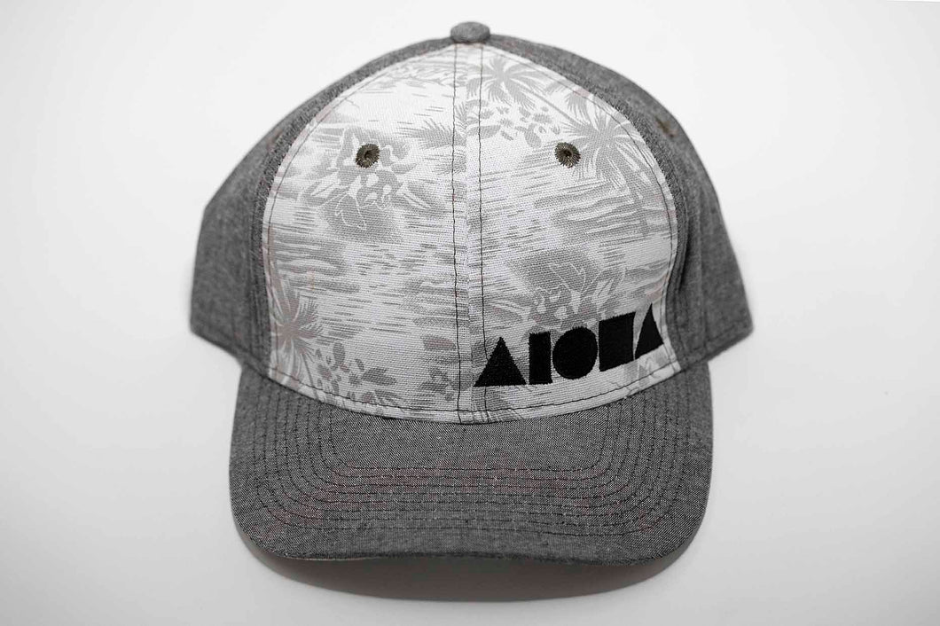 Grey denim and tropical palm tree print fabric Adult curved bill snapback hat embroidered in Maui Hawaii with black Aloha Shapes logo