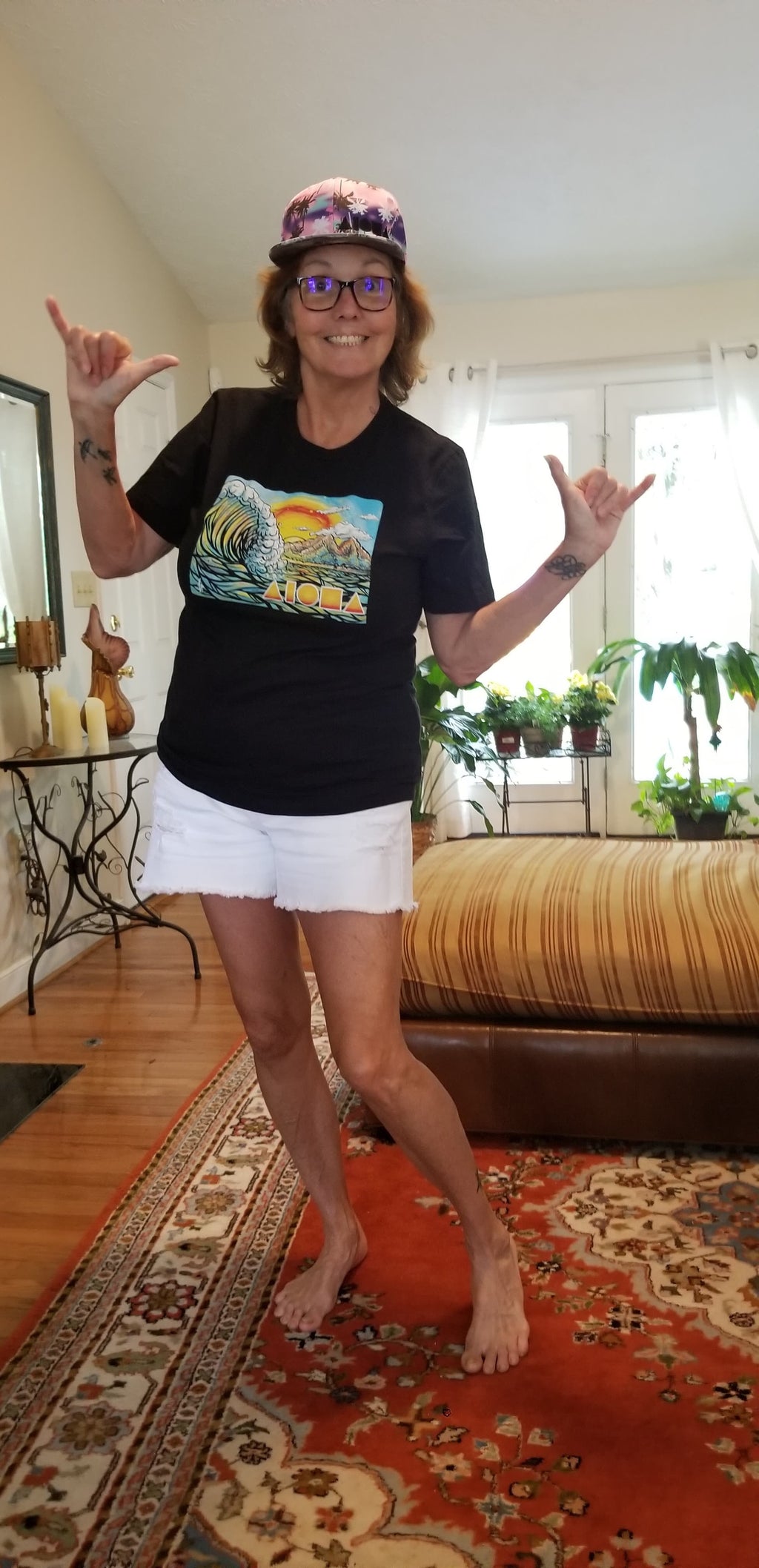 woman wearing Cartoon drawing of west side Maui beach surf spot designed in Big Island Hawaii and printed in Maui, Hawaii throwing shakas