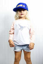 Cute young blond girl wearing an Aloha Shapes® youth trucker hat made in Maui, Hawaii