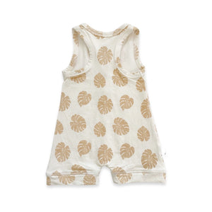 Baby/toddler romper designed in Maui Hawaii. Tan color fabric with honey brown monstera leaf print. Back view