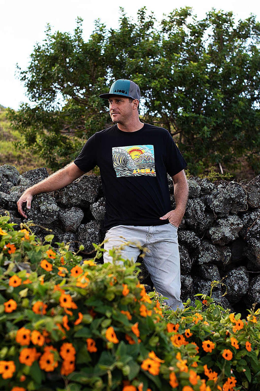 Man wearing t-shirt of Cartoon drawing of west side Maui beach surf spot designed in Big Island Hawaii and printed in Maui, Hawaii